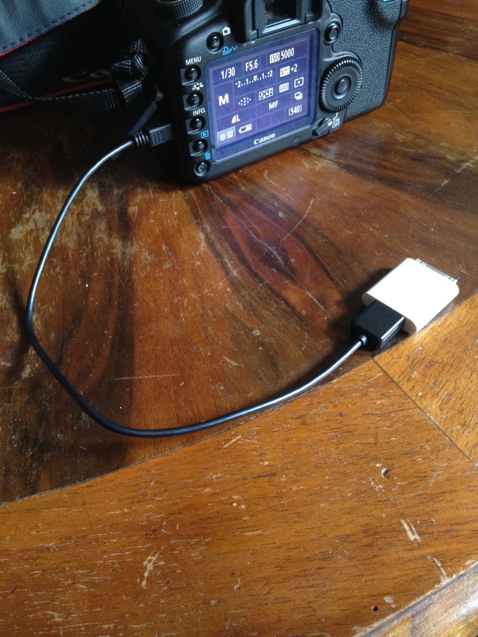 Plug the cable in your camera and make sure it is turned on (most cameras get in transfer mode as soon as you plug them in the iPad some others might need some setup you'll find answers in the manual)