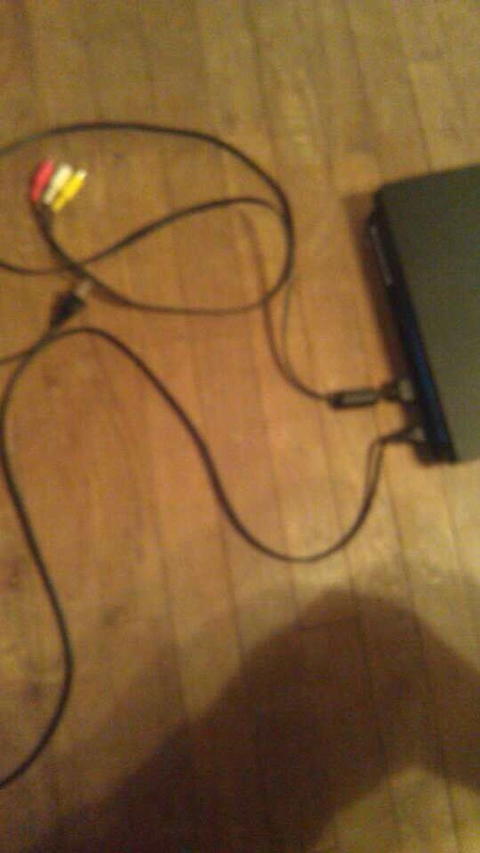 Plug the Composite AV cord into the back of the console