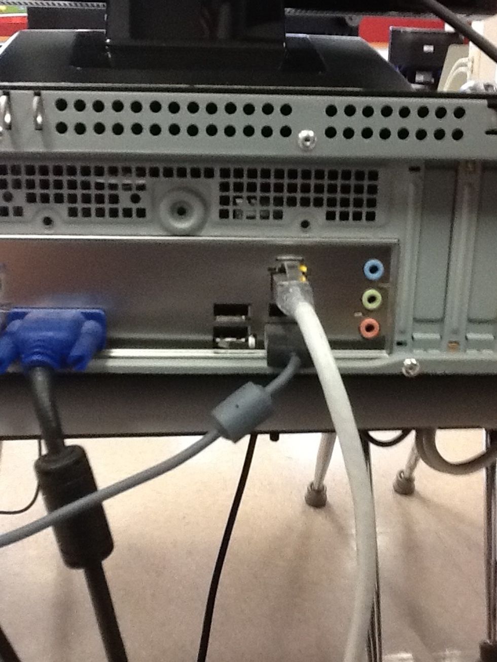 Plug the headphones into the sound card on the back of the computer (green).