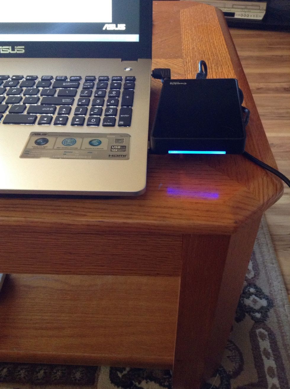 Plug the other end into your new computer's USB port and you will get a pretty blue light!