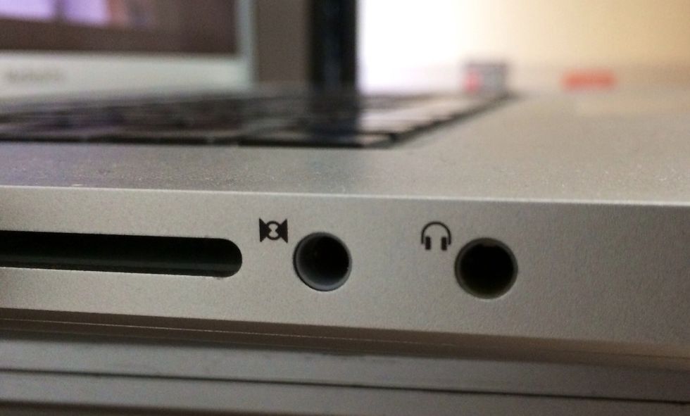 Plug the other end of the auxiliary cable into the audio in jack on the left side of your MacBook Pro. It is the one with the icon that looks like a circle with 2 triangles.