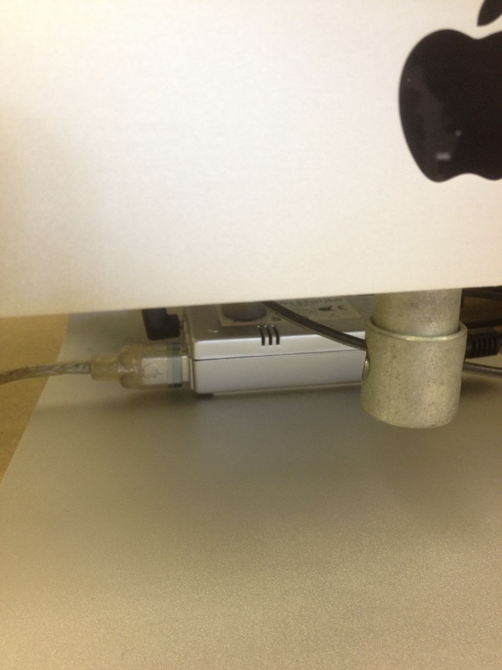 Plug the other end of the cable into the firewire hub underneath the iMac.