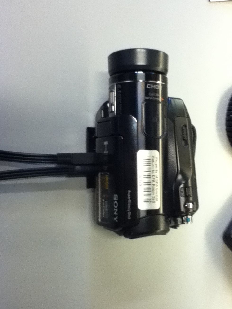 Plug the two cables in the lower left panel of the camera.