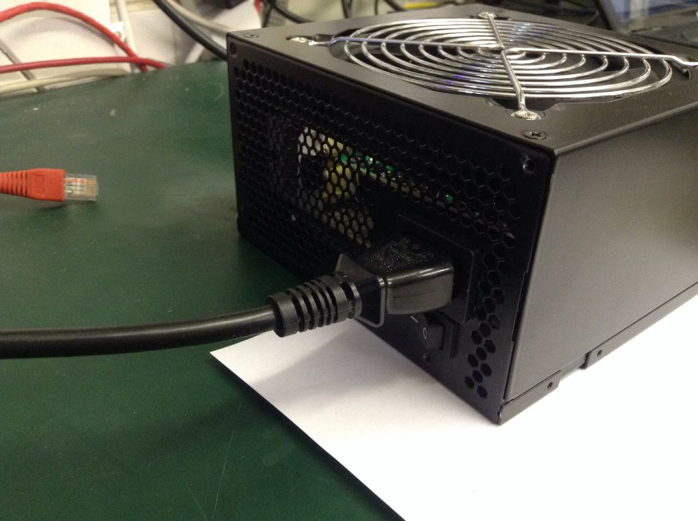 Plug you PSU into the mains with a 3-pin kettle lead and make sure the power switch (if there is one) is switched to the ON position.