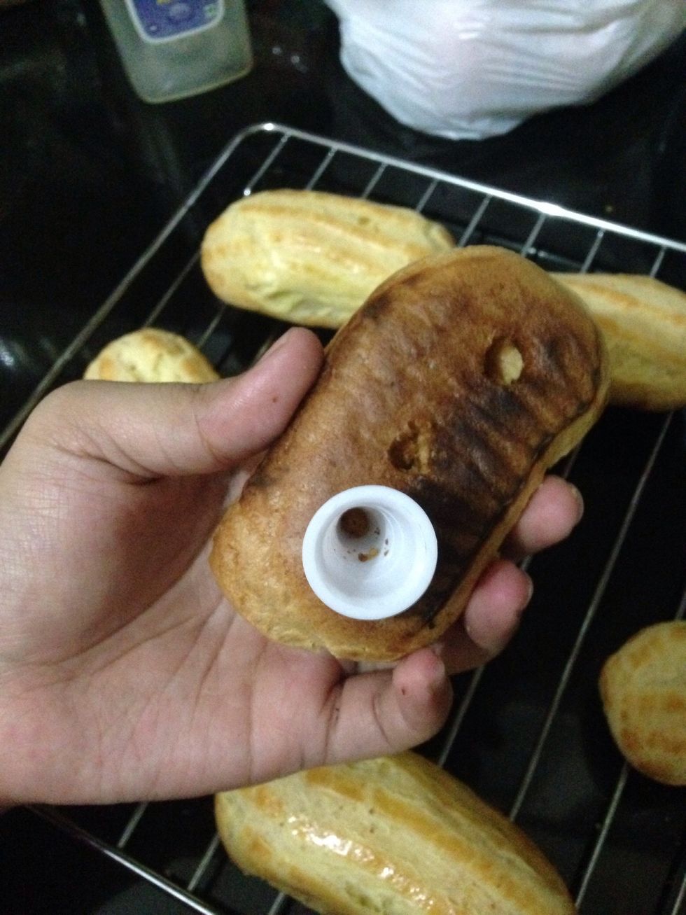 Poke 3 small holes at the bottom of baked eclairs. Mine got slightly burned at the bottom, but thats okay, its still good \ud83d\ude02 Place them back on wire rack to cool
