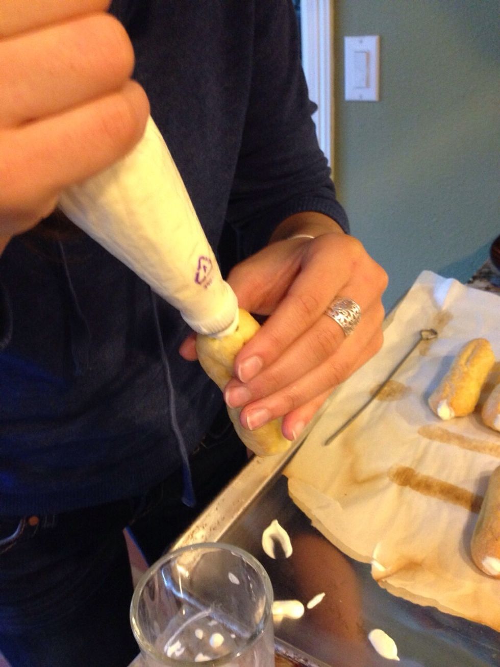 Poke a hole in each end of eclairs, and fill with cream!