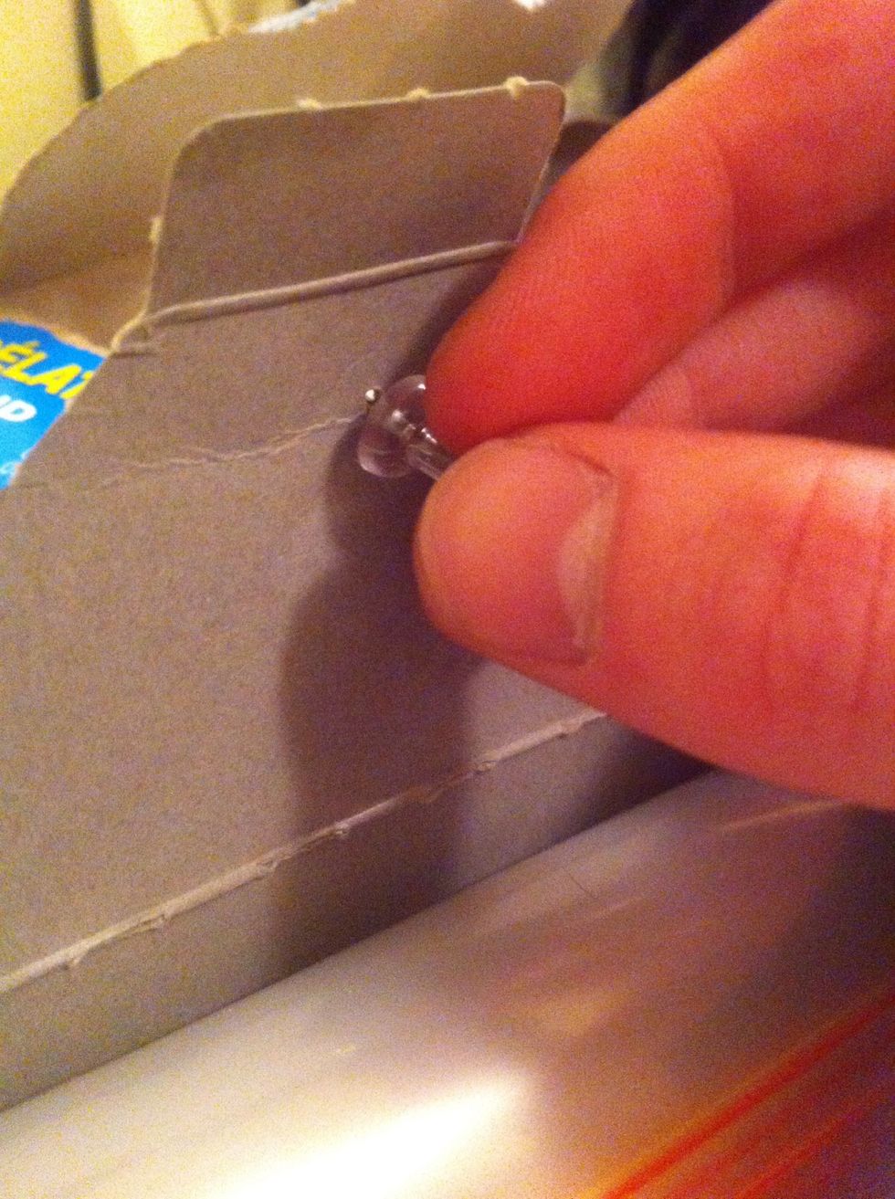 Poke a hole through the flap first, this way it makes screwing in the tack easier.