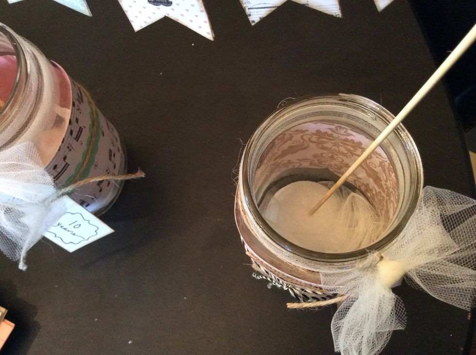 Poke banner stakes into the styrofoam, anchoring banner. Cover styrofoam with layers of tulle or burlap.