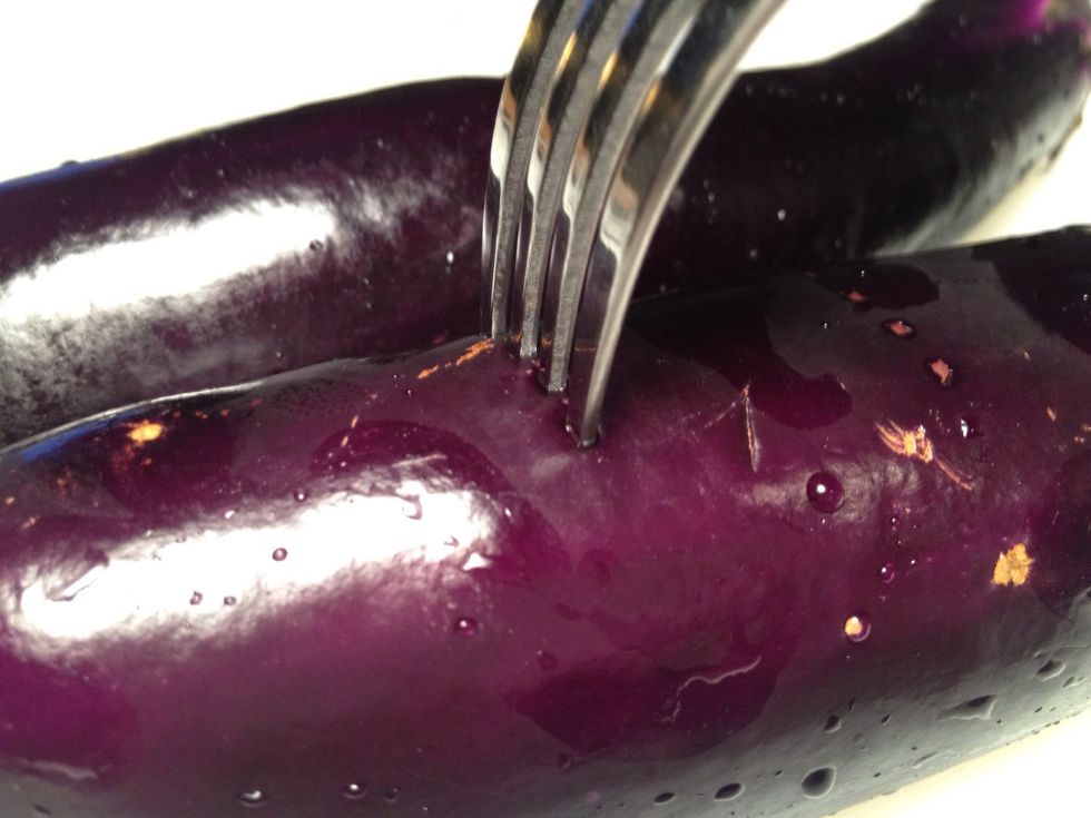 Poke holes in eggplants using a fork. This allows steam to escape while baking.