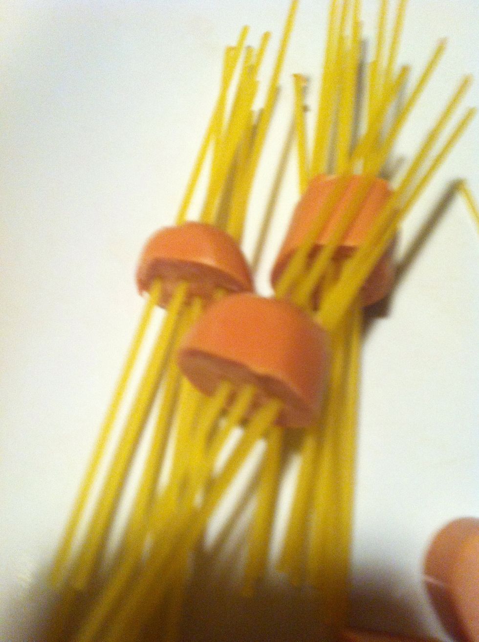 Poke spaghetti through the meat