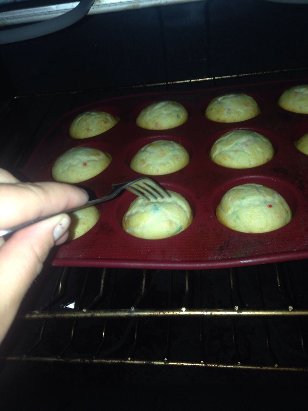 Poke the center of a cupcake with a fork/toothpick to make sure they are cooked thoroughly. If the fork/toothpick comes out without any residue, the cupcakes are done and can be pulled out of the oven