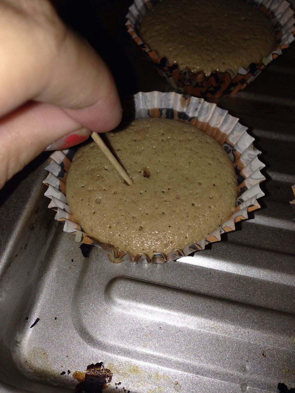 Poke the cupcake with a toothpick to see if it's done.