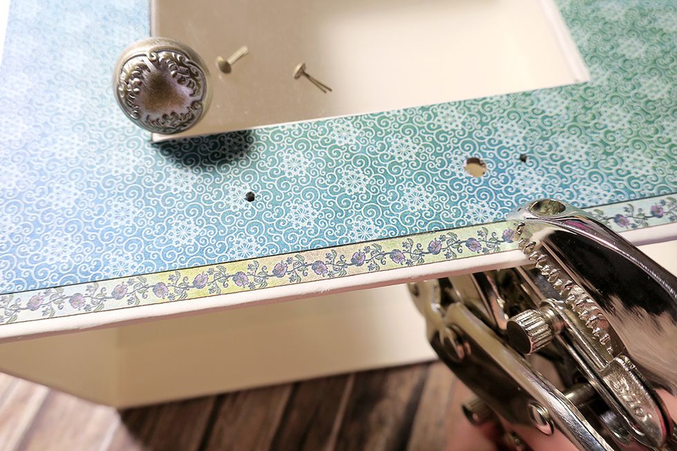 Poke the holes with an awl, and use a Crop-A-Dile for punching a larger hole for a knob.