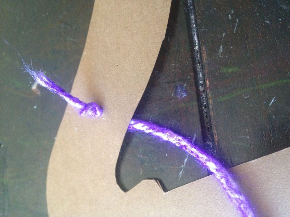 poke the string through and make a knot. this will take some finesse, kind of like threading a needle.