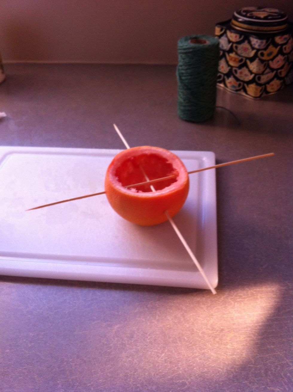 Poke your sticks through your fruit so they cross over each other