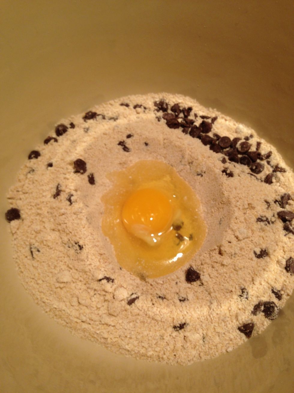 Ponga la mantequilla y un huevo en la masa para galletas.