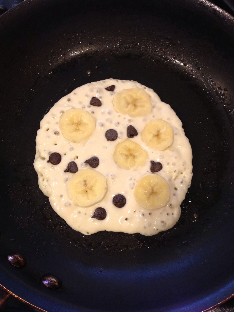 Poor 1/4 cup of batter onto prepared well buttered non stick pan. Sprinkle with chocolate and thin banana slices. Don't skimp on either! :)