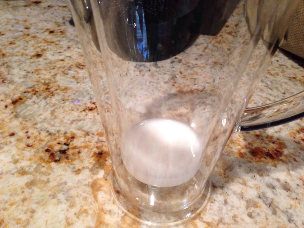 Poor a bit of milk into the bottom of a tall glass and fill with ice.