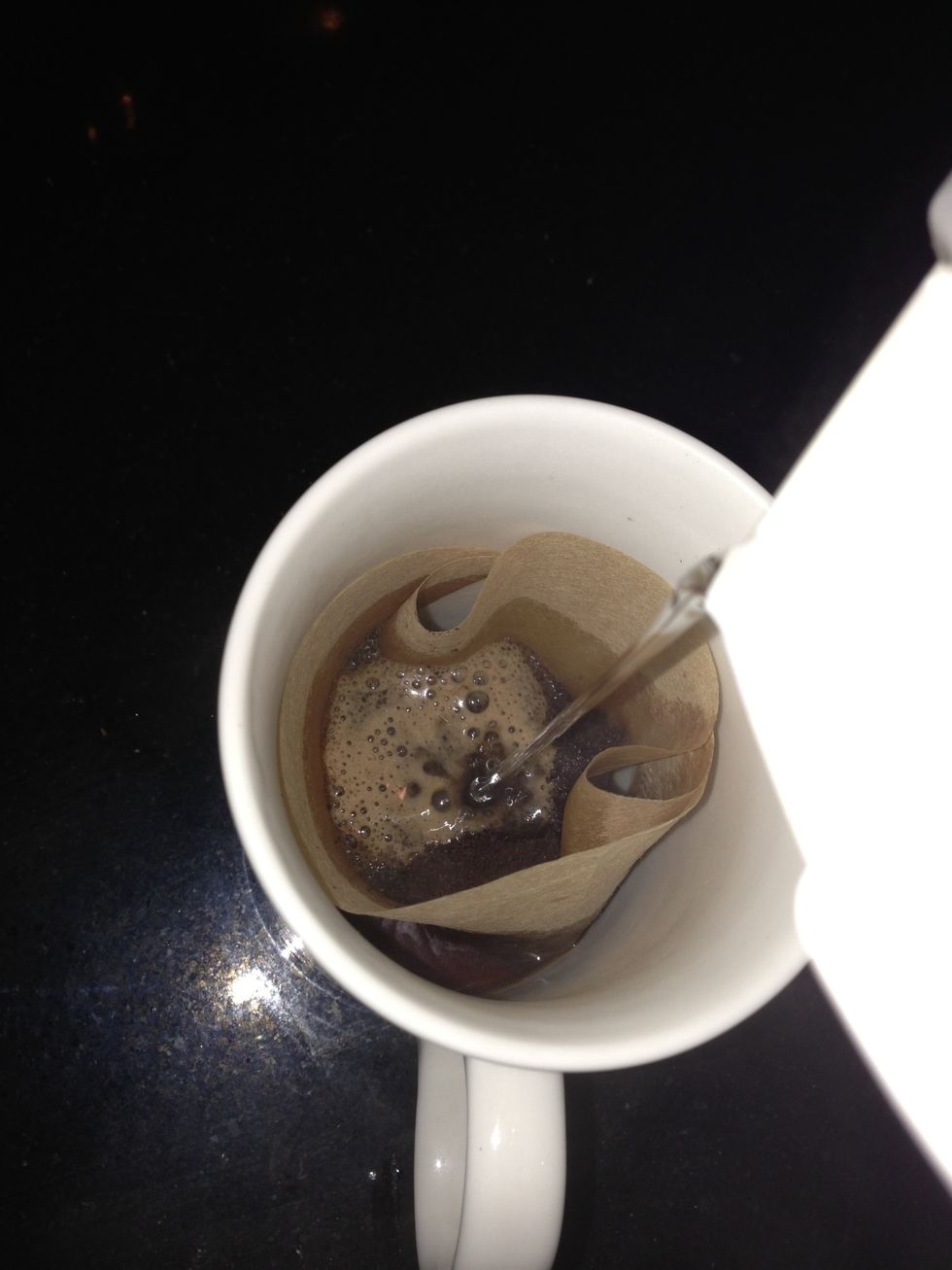 Poor freshly boiled water on top, at this point your filter may slip in, so carefully pull it out and wrap it around the mug with your hands in place