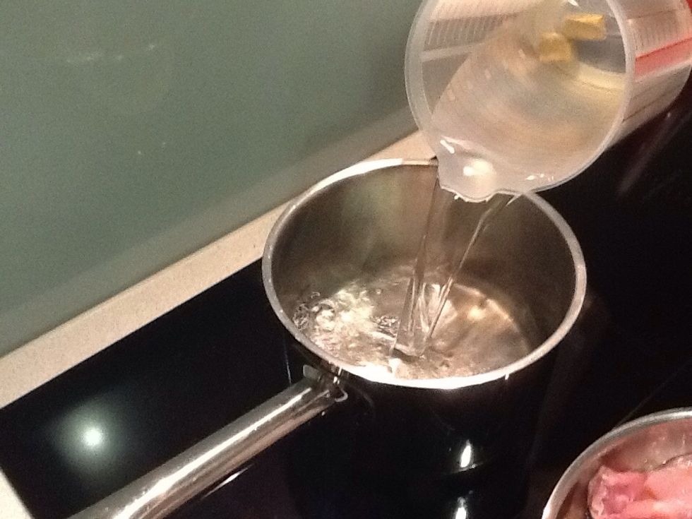 Poor the chicken stock into a saucepan and bring to the boil, turn down the heat and simmer with the lid on.