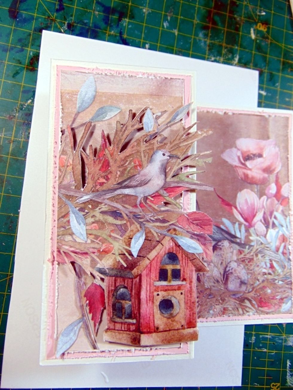 Pop the birdcage and branches up with sticky foam dots and fix to the front of the card. (folded back piece) Slot the extra 2 branches in, one at top and one hanging down side of birdhouse.