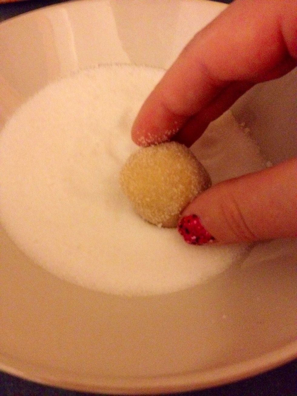 Pop the bowl into the freezer for about 10 minutes. Will be easier to handle. After chilling, roll the dough into balls then roll in sugar.