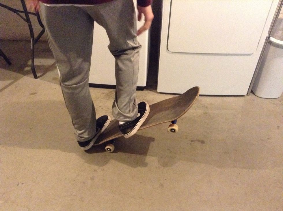 Pop the tail of your board on the ground.