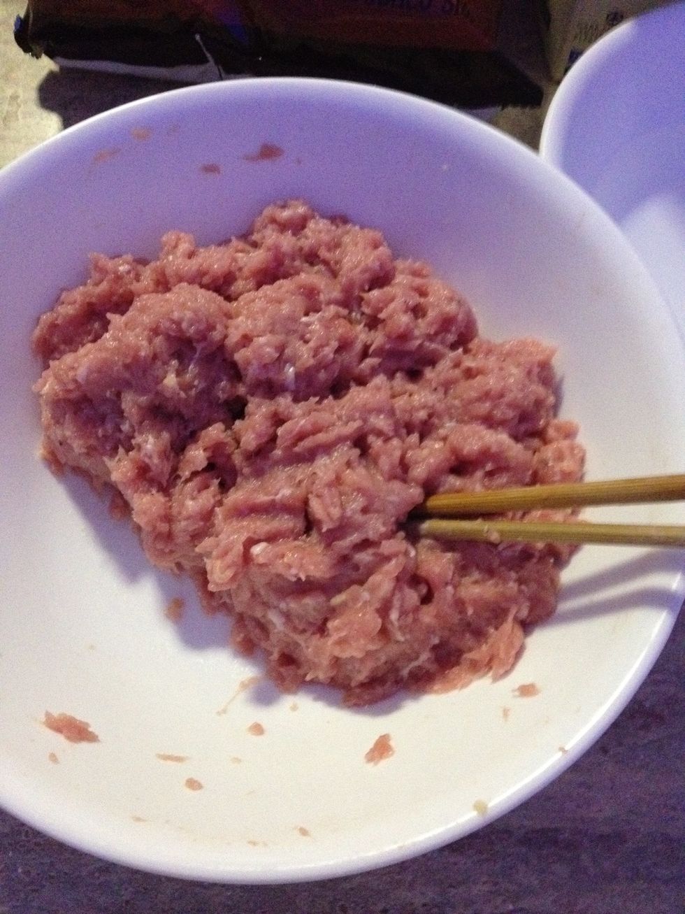 Pop your 1/2 kg of pork mince in a large bowl and add the finely chopped ginger (about 1 teaspoon), about 1/2 teaspoon of salt and some pepper.
