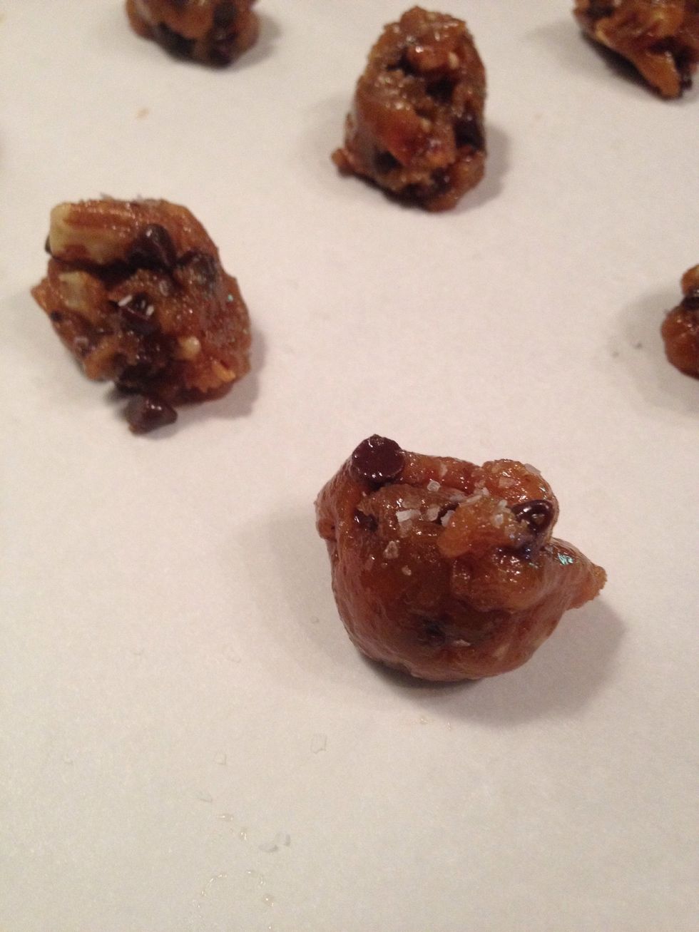 Portion out the dough onto a parchment lined cookie sheet. Sprinkle a tiny amount of kosher salt onto the top of each cookie. Bake at 350 for 10-12 minutes.