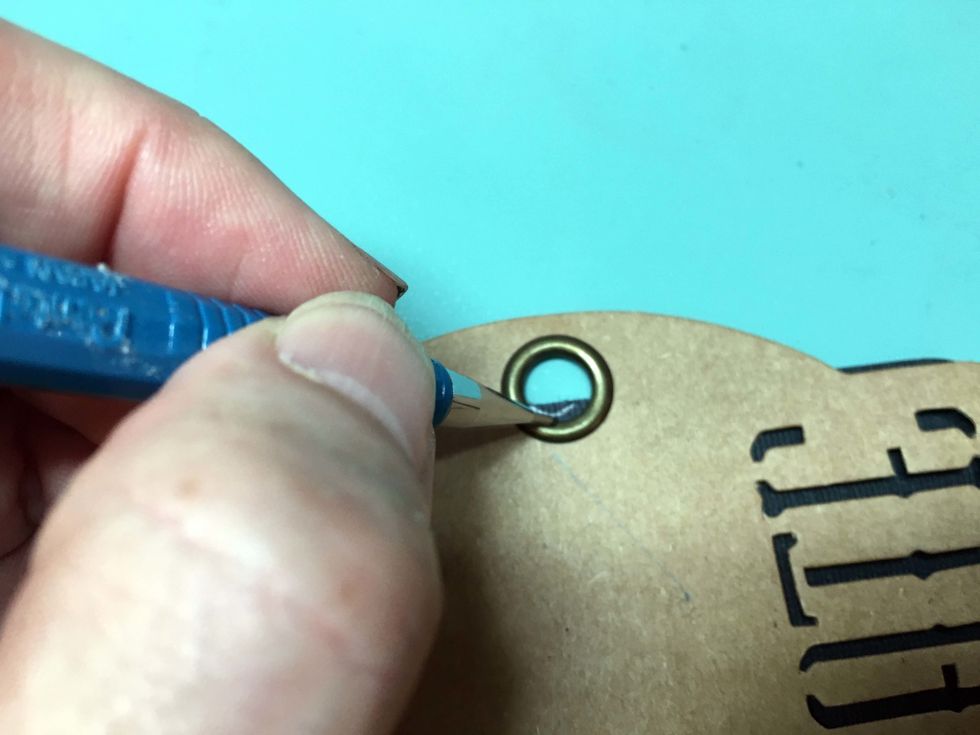 Position the cardstock over the Celebrate tag and mark the cardstock where it covers the hole.