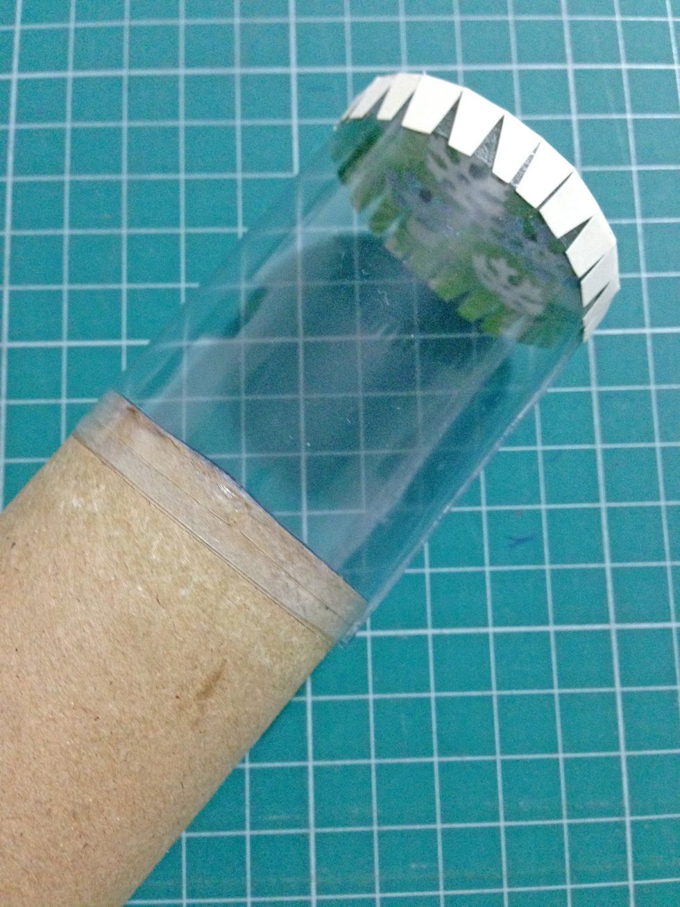 Position the circle with the snowflake brads (or gems) onto the acetate with the tabs adhereing down as shown... Cover the acetate tube with vellum/tracing paper (which you prepared in Step 11)...