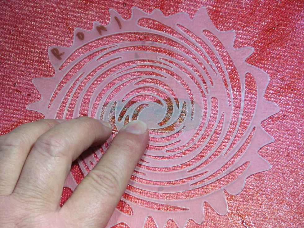 Position the hypnotist swirl over the eyes/mask so it looks like the rays radiate from them.