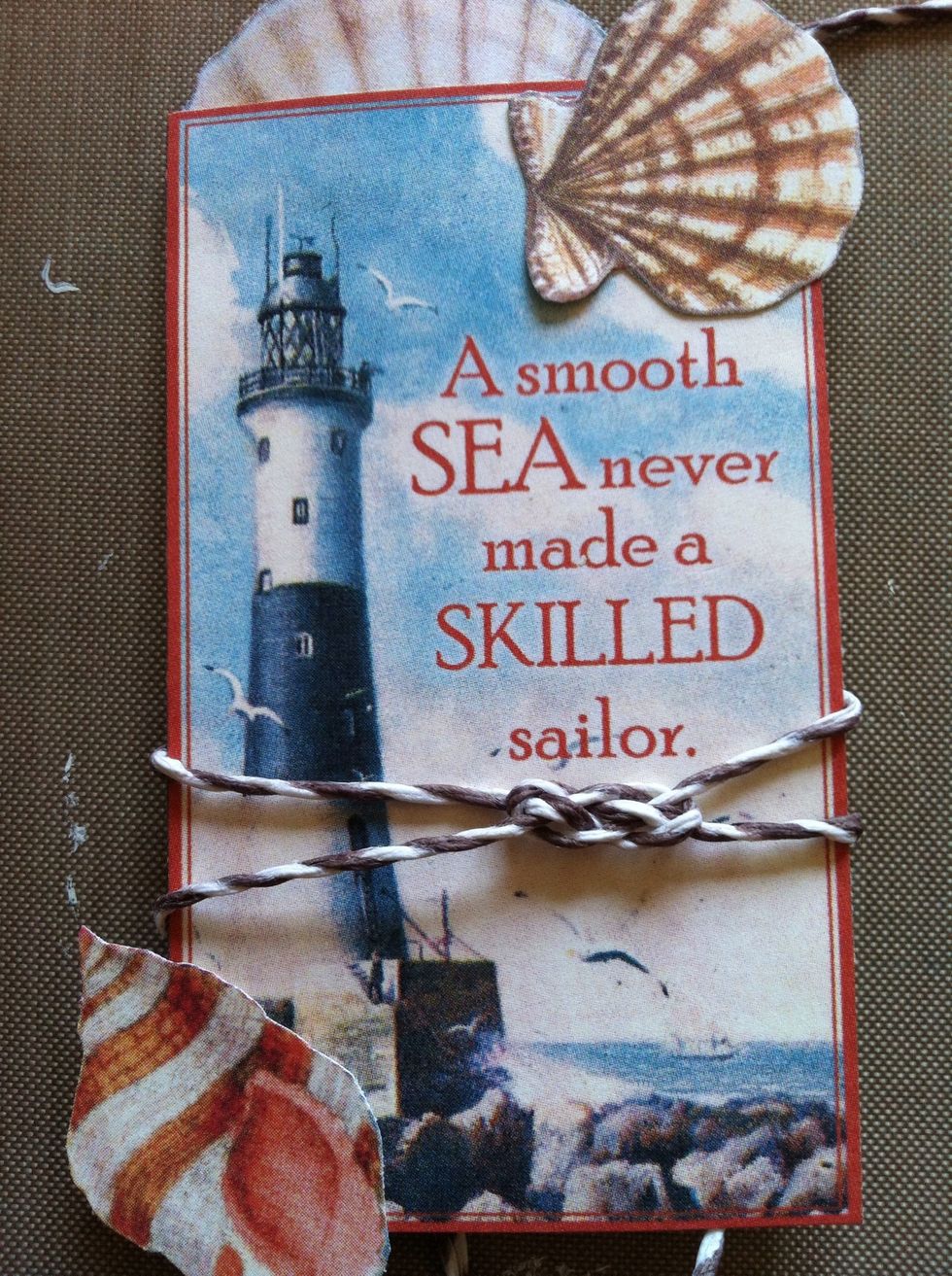 Position the knot under the "sailor" on the pop-dotted card. Adhere it in place with a bit of glue on the back of the card only. Trim your excess twine.