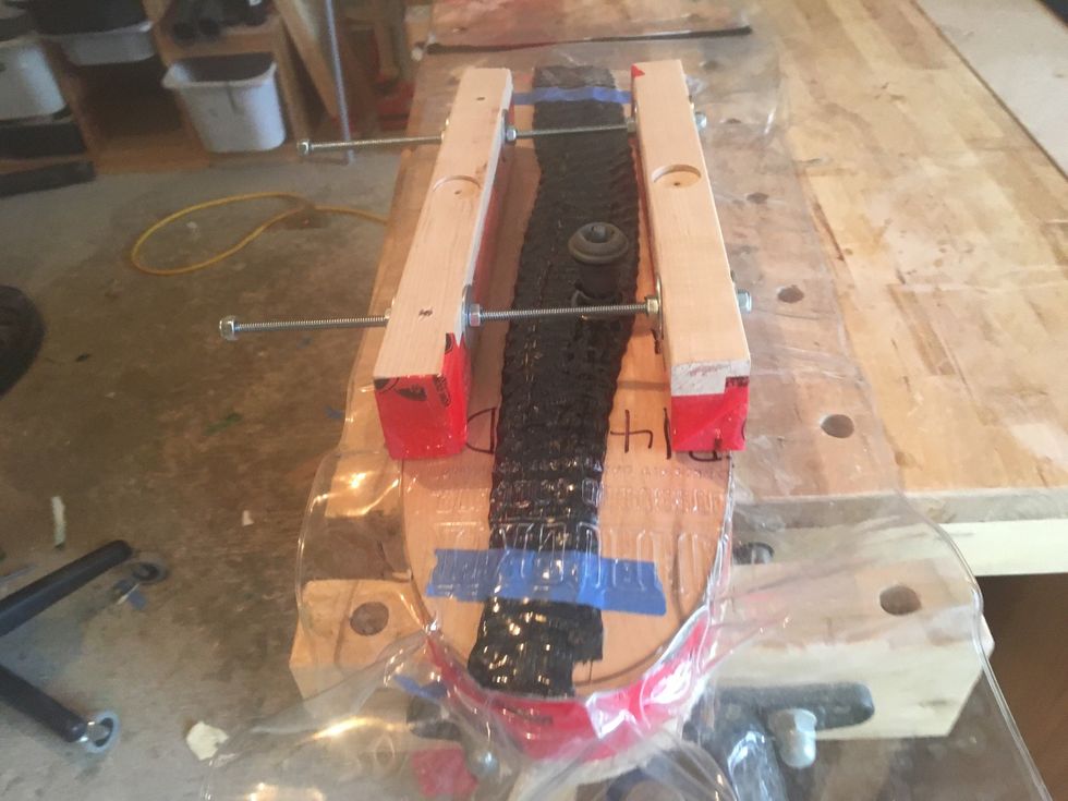 Position the pair of clamping cauls to ensure access to the valve.