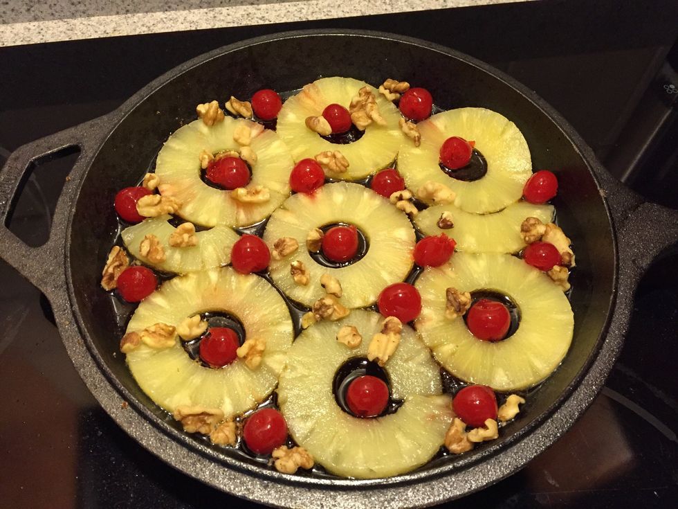 Position the pineapple, cherries, and walnuts.