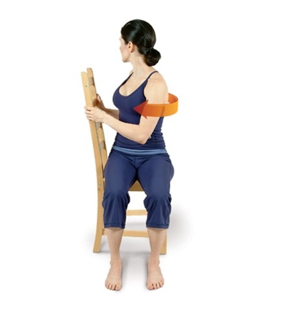Position the right side of your body facing the chair back & hold the chair back with your hands at shoulder height. Twist to the right to move into Chair Twist.