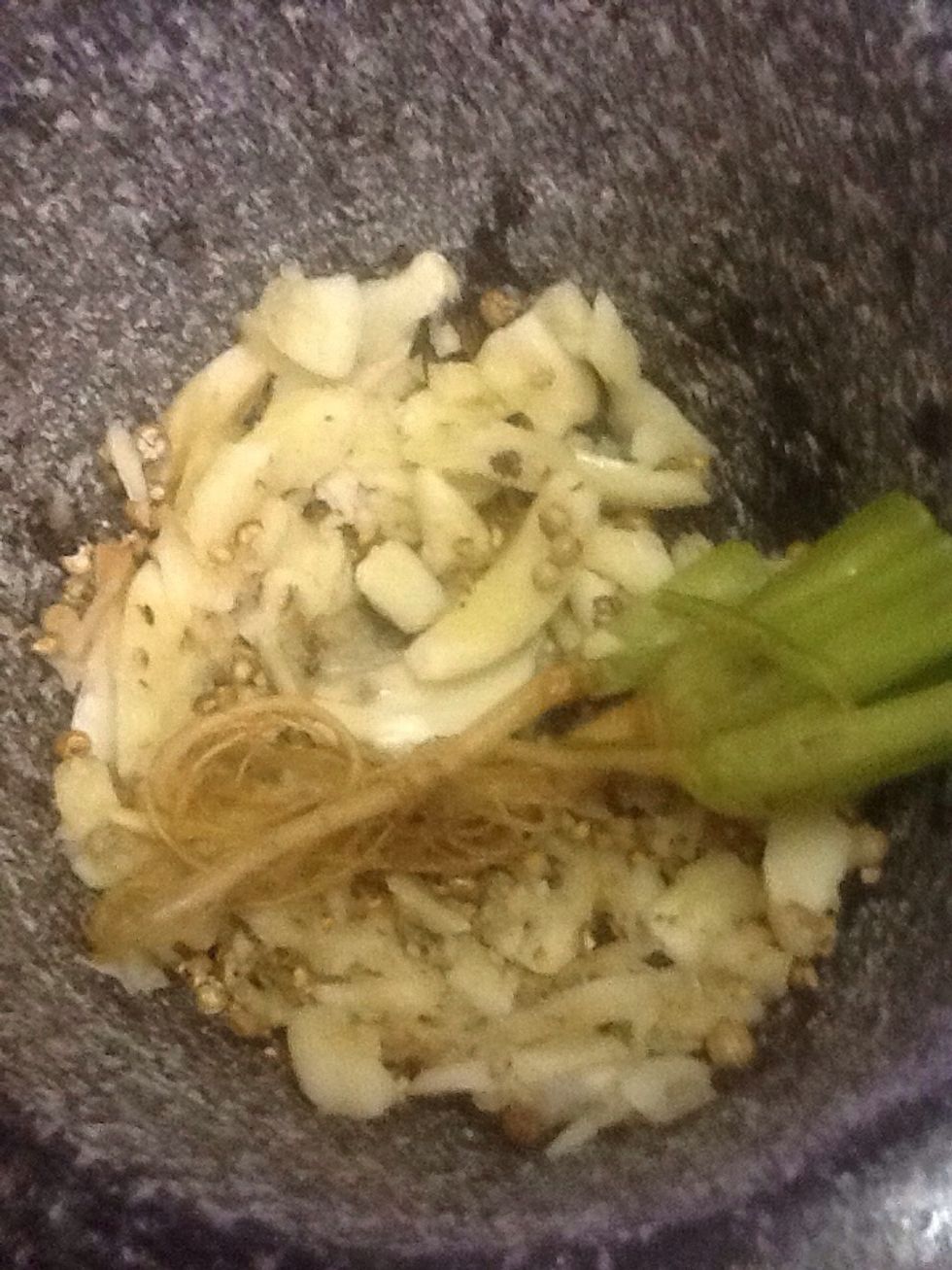 Pound garlic,pepper and coriander roots together