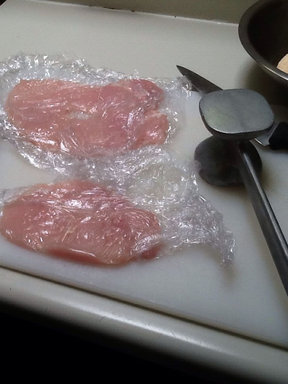 Pound the chicken to make it equal in thickness (with hammer on the right).