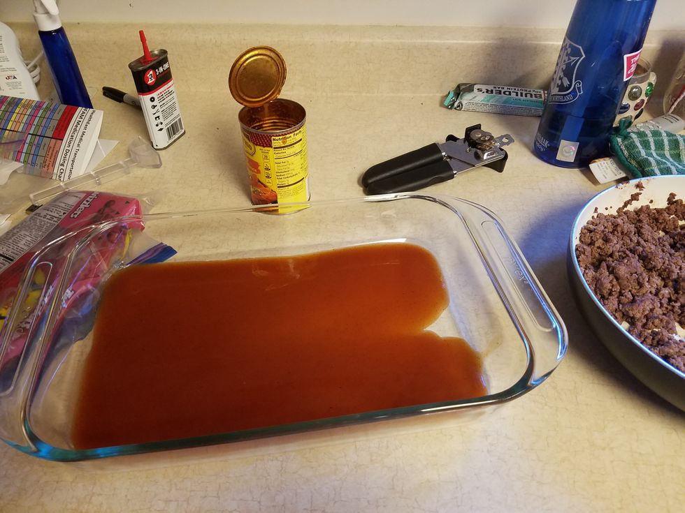 Pour 1 1/4 cup enchilada sauce on the bottom of the pan