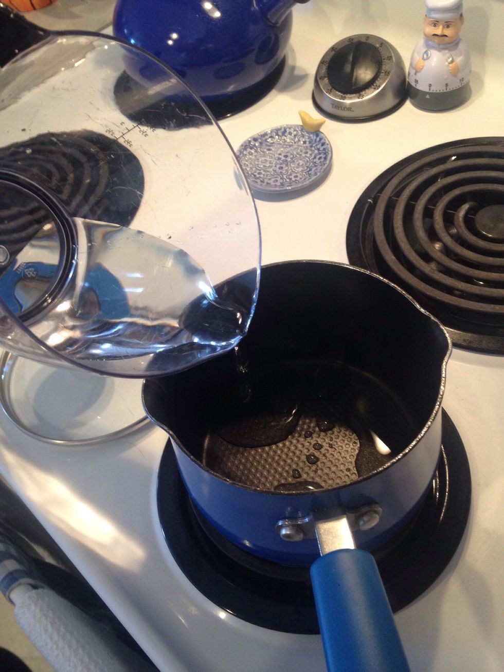 Pour 1/2 cup water into a small sauce pan.