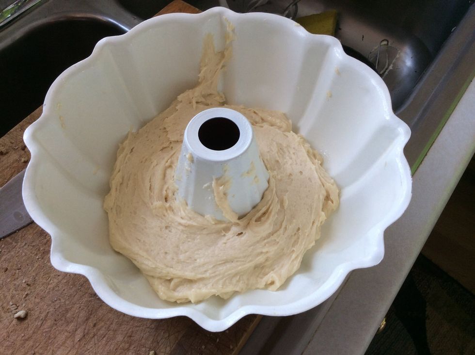 Pour 1/2 of the cake mix (first bowl) into the pan.