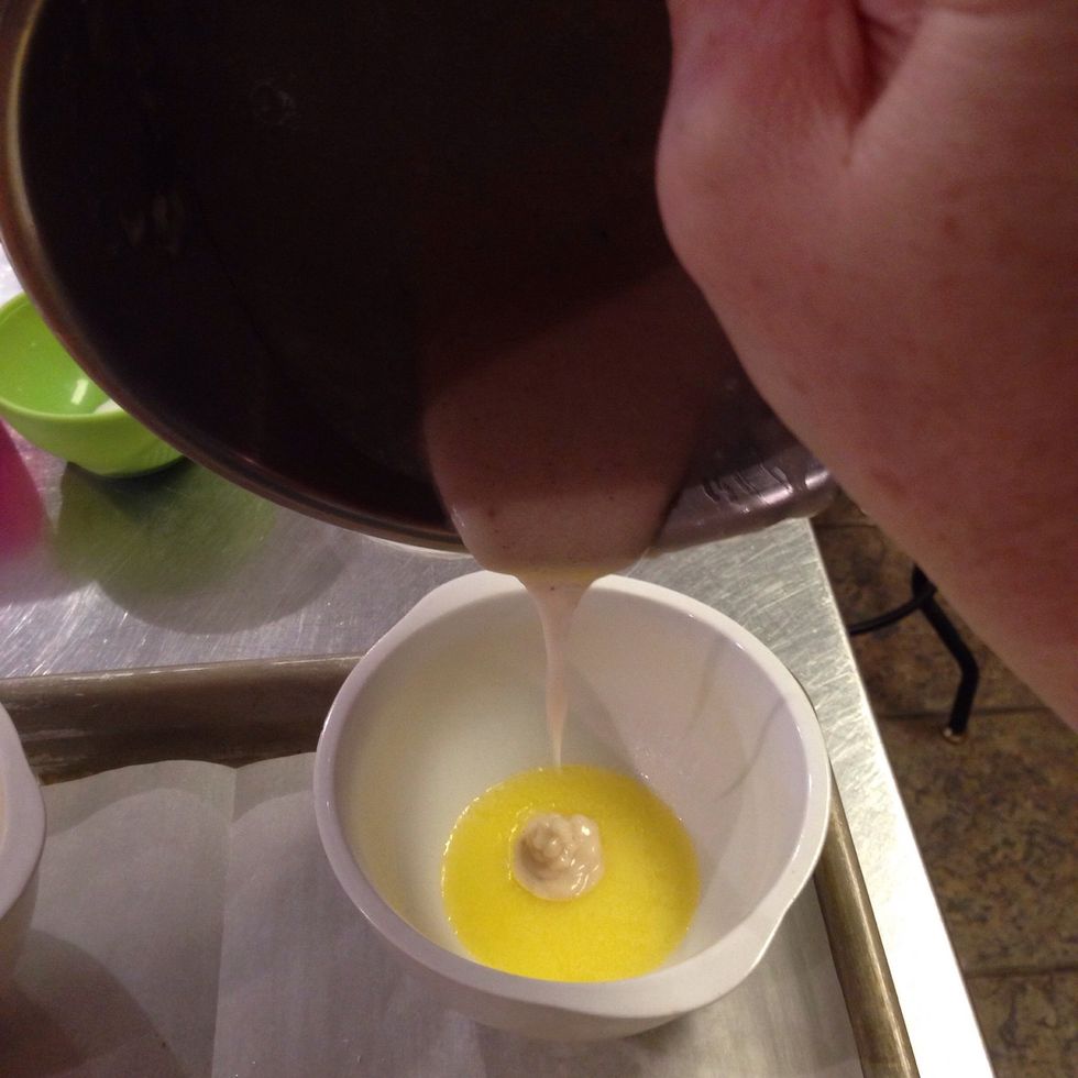 Pour 1/2 of the flour mixture in each ramekin on top of the butter. DO NOT MIX.