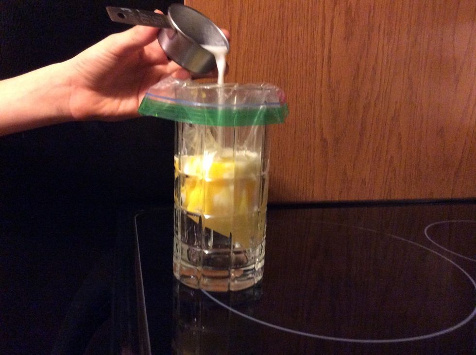Pour 1/3 cup of milk in the zip lock bag.