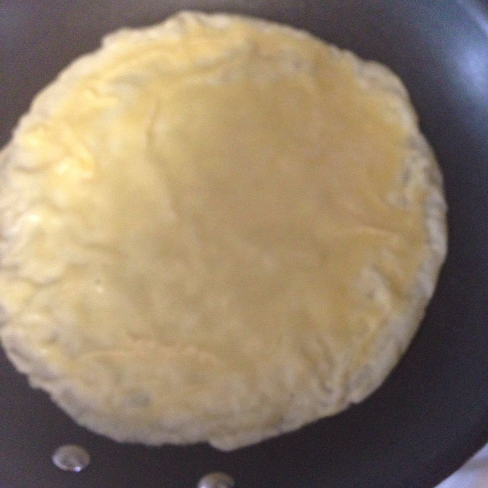 Pour 1/3 rd cup of crepe mixture in the center and rotate the pan to get a round shape