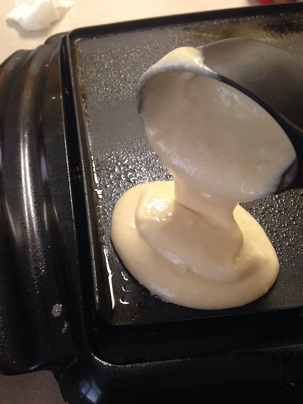 Pour 1/4 cups of pancake batter on your grill.