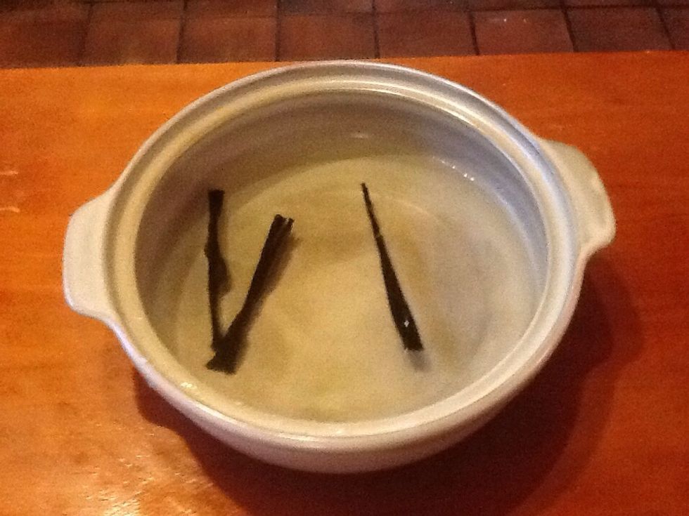 Pour 1 litre of water into a large clay pot. Drop 3 10cm strips of dried seaweed (kombu) in and leave for 2 hours