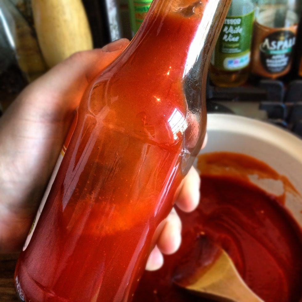 Pour 100ml of the water into the ketchup bottle, shake well and add to the sauce. Turn down the heat to a very low simmer.