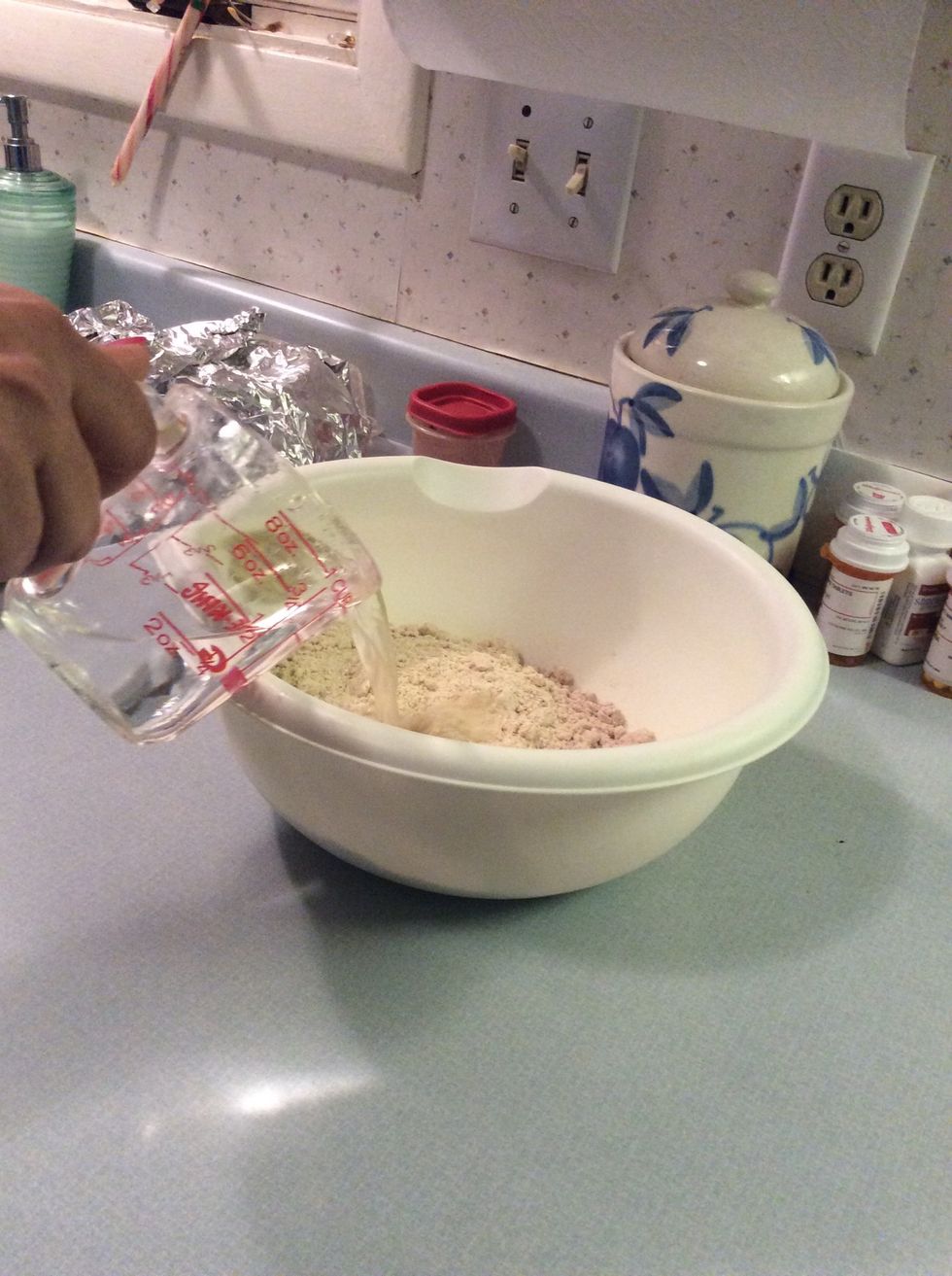 Pour 2/3 cup water and 1/3 vegetable oil and one egg into bowl also
