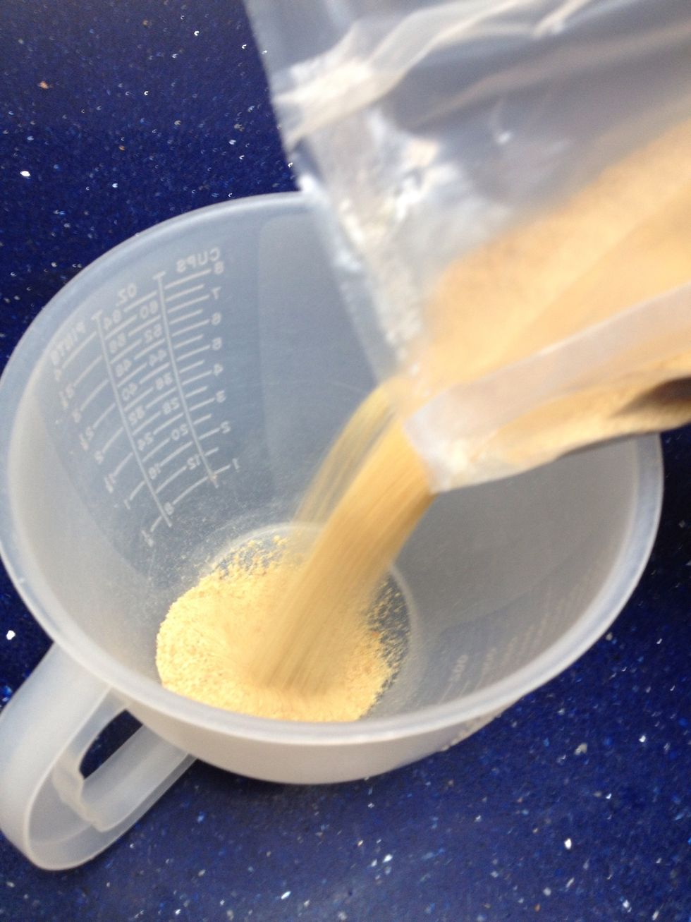 Pour 2 cups of the graham cracker crumbs into a microwavable dish