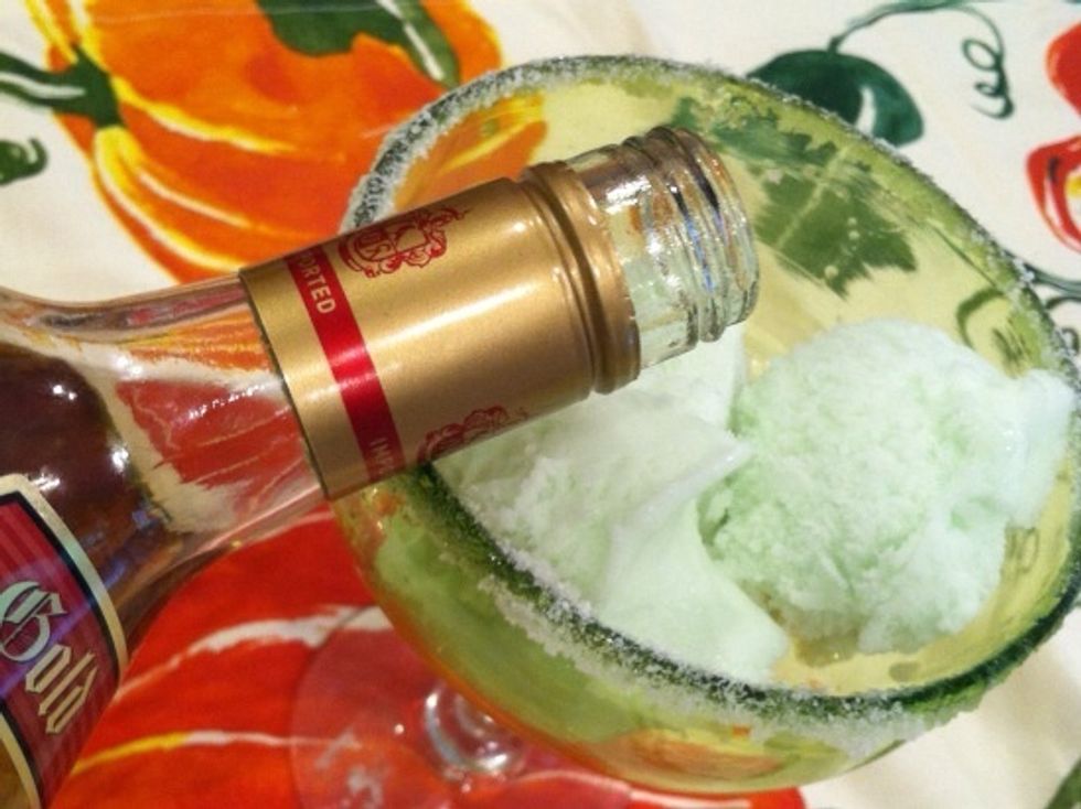 Pour 2 tablespoons of tequila over the sherbet.